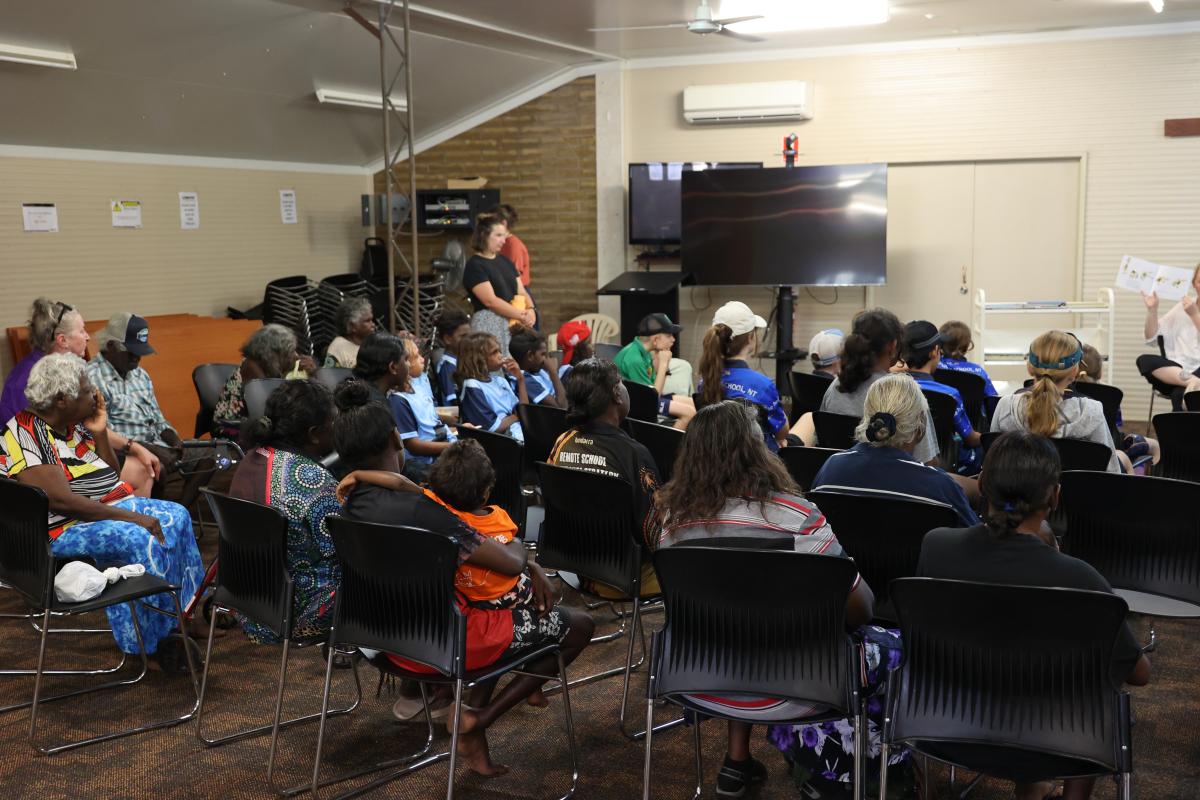 Crowd of people sitting in a hall 