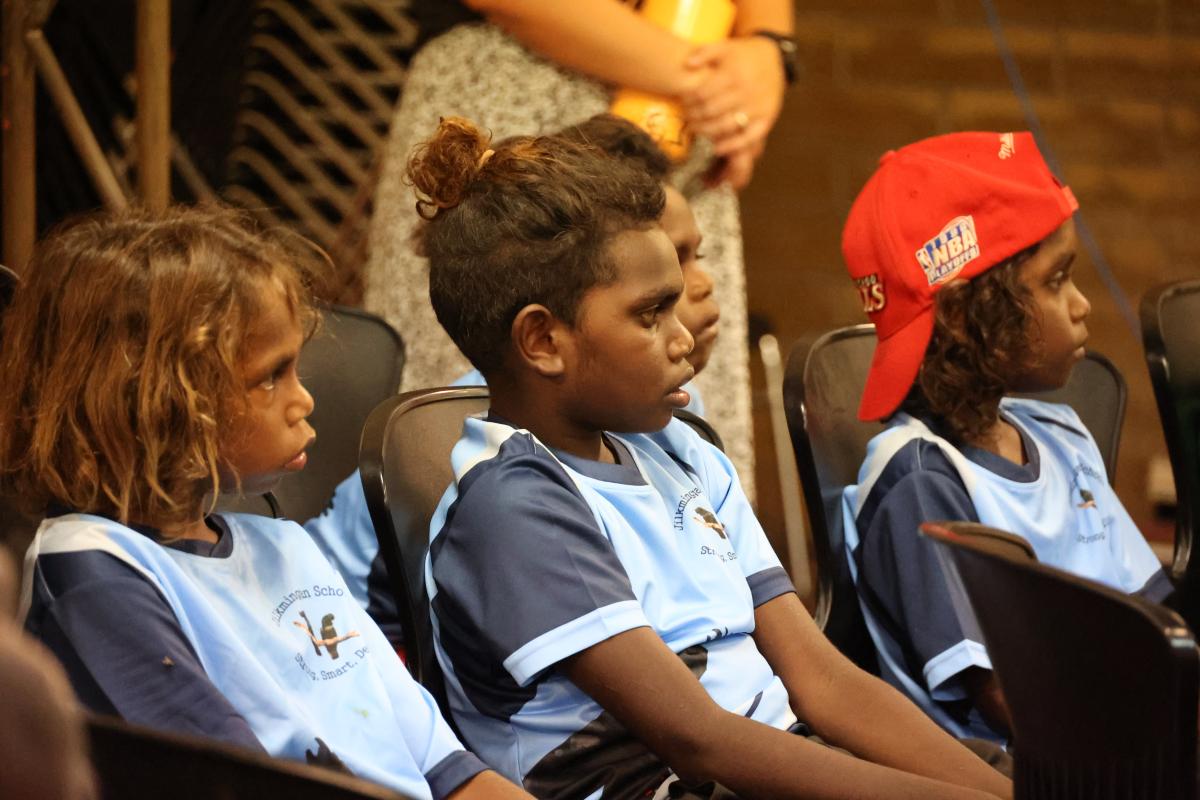 4 students sitting on black chairs