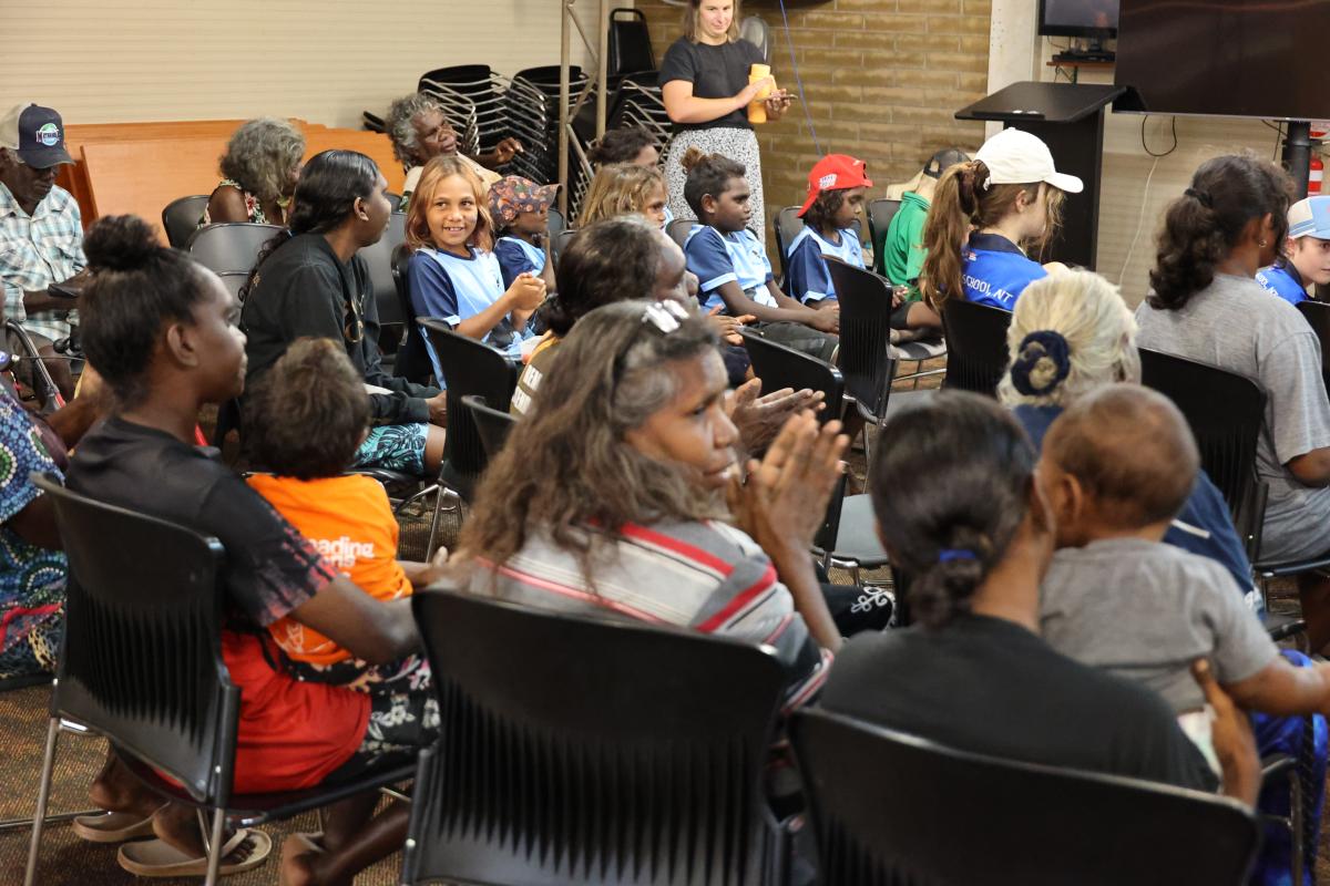 Crowd of people sitting in a hall applauding
