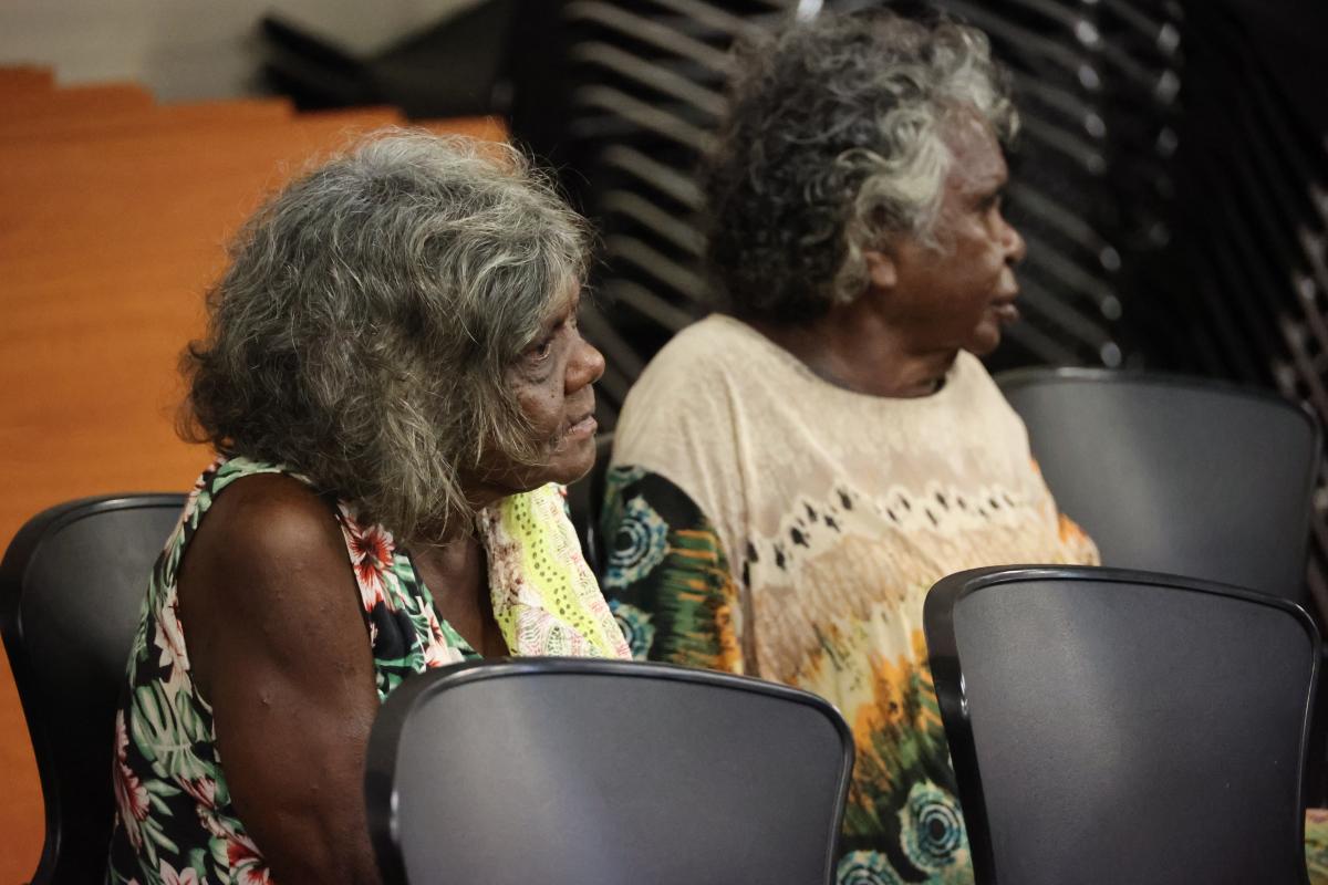 2 elderly women sitting on black chairs 
