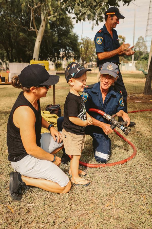 Young child with emergency service workers at markets