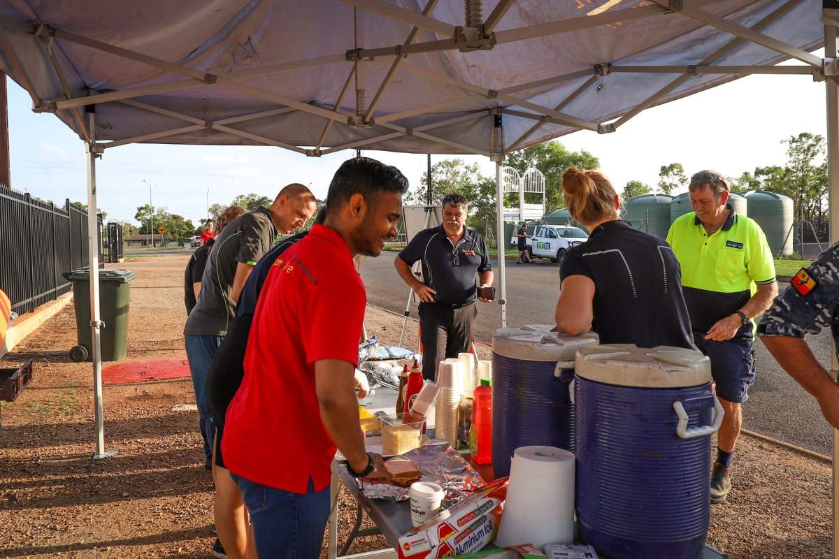 Council staff preparing bacon and egg rolls